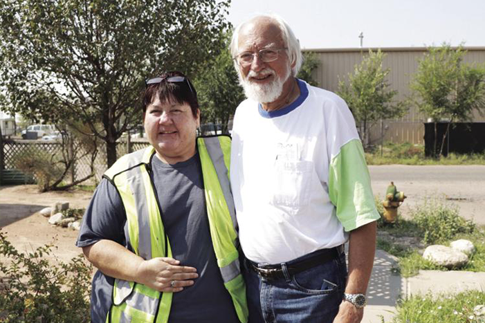 Photo by Stephen Montoya Homeowner Ancilla Quintana, left, stands next to Jerry Saxton, volunteer and board member for Rebuilding Together at Southern Sandoval County. Saxton helped install the new swamp cooler on Quintana’s roof.